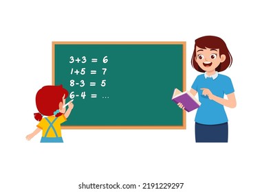 little kid solving math problem on blackboard