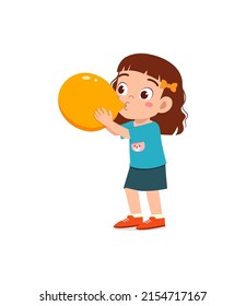 little kid standing and blowing a balloon