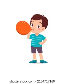 little kid standing and blowing a balloon