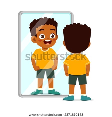 little kid standing in front of mirror