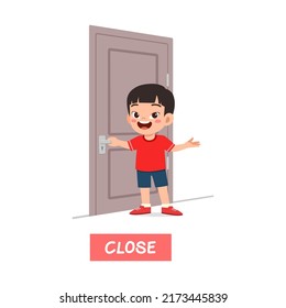 Little Kid Standing And Holding Door Knob