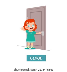 little kid standing and holding door knob