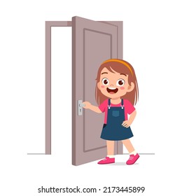 little kid standing and holding door knob