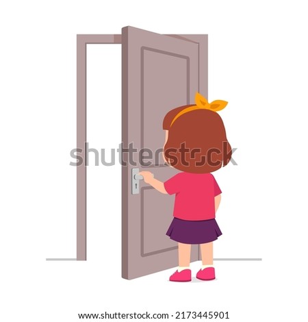 little kid standing and holding door knob