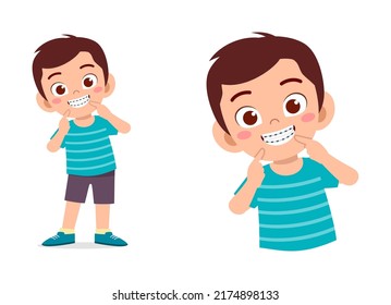 little kid using dental braces and feel happy