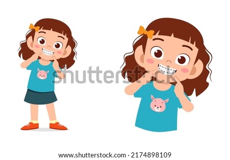 little kid using dental braces and feel happy