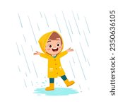 little kid wearing yellow rain coat in the rain and feel happy