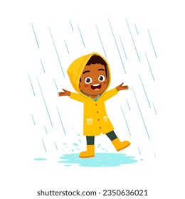 little kid wearing yellow rain coat in the rain and feel happy