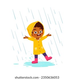 little kid wearing yellow rain coat in the rain and feel happy