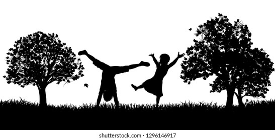 Little kids or children playing in the park or exercising outdoors in silhouette