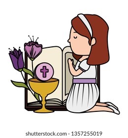 little kneeling girl with bible and flowers first communion