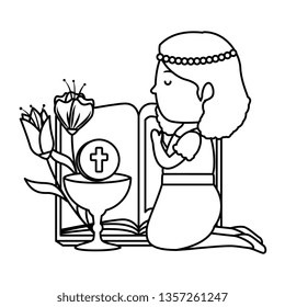 little kneeling girl with bible and flowers first communion