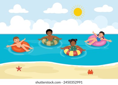 Little multi-ethnic kids with inflatable swim rings having fun in the sea at the beach