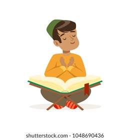 Little muslim boy sitting on floor with crossed legs and studying Koran. Islamic religion. Kid wearing national headdress. Cartoon child character. Flat vector design