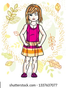 Little red-haired girl toddler standing on background of autumn landscape and wearing fashionable casual clothes. Vector attractive kid illustration. Fashion and lifestyle theme cartoon.