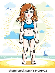Little redhead girl toddler standing on sunny beach and wearing swimming suit. Vector kid illustration. Summer holidays theme.