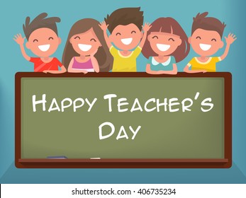 Little schoolchildren at the blackboard. Happy Teacher's Day
