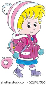 Little schoolgirl in a winter jacket and a warm hat and mittens going with a schoolbag