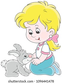 Little smiling girl playing with her small grey rabbit, vector illustration in a cartoon style