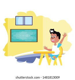 little student boy sitting in school desk in the classroom