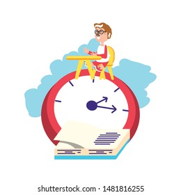 little student boy sitting in school desk with clock