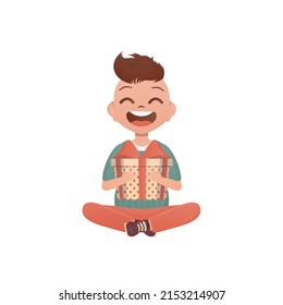 A little teen boy sits in a lotus position and holds a box with a bow in his hands. Birthday, New Year or holidays theme. Cartoon style isolated on white background.