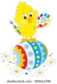 Little yellow chick painted an Easter egg