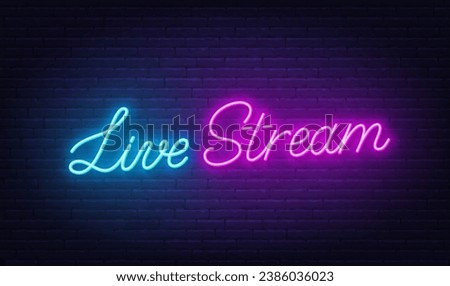 Live Stream neon sign on brick wall background.