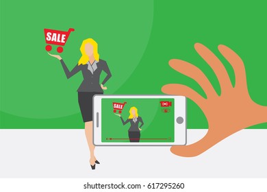 Live Video And Online Marketing Concept. A Hand Holding Mobile Phone To Capture And Broadcasting Live Sale Presentation On Green Screen.