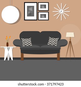living room with sofa small desk hanging and standing lamp brown wall dark sofa