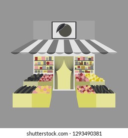 Local fruit and vegetables store building. Groceries crates in front of storefront