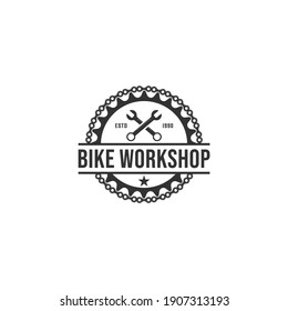 logo for bicycle repair shop with illustration of bicycle gear and repair tools