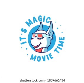 The logo dragon is watching a film. Cartoonish monster in the blue circle with a lettering phrase - It is magic movie time. Good for t-shirts, cloth designs etc. Vector illustration 