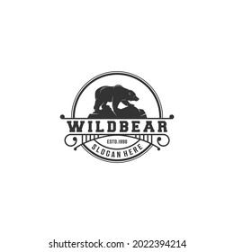 logo illustration of a bear walking on a rock on a white background