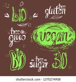 Logo label bio, vegan, natural on a green background.Gmo free, calligraphic handwriting lettering with leaf, cube, drop. natural food sticker eps 10