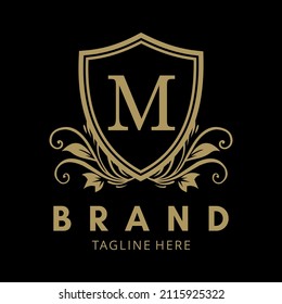 LOGO M IN GOLD COLOR SHIELD