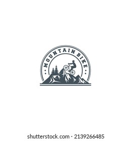 logo for mountain bike sport with illustration of a cyclist pedaling his bicycle in the mountain