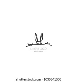 Logo of the rabbit. The hare sits in the grass and looks ahead. The symbol is made in a linear-minimalist style. Vector object is isolated on white background.
