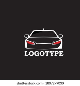 The logo is in the shape of a car in white and there is a red light in front of the car