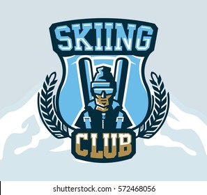 Logo skiing club. Emblem of skier in a cap and ski glasses, backpack and skis. Extreme winter sport. Isolated mountains in the background. Badges shield, lettering. Vector illustration.