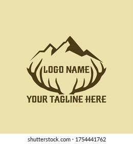a logo that forms a mountain and deer antlers
