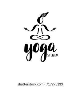Logo for yoga studio or meditation class. Meditation concept. Silhouette of sitting woman and lettering phrase Yoga studio.Vector illustration for t-shirt print, yoga mat, towel, poster, business card