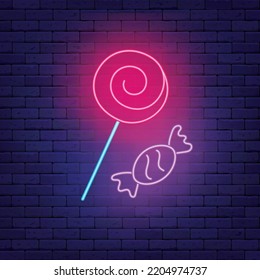 Lollipop and candy neon icon. Trick or treat design. Sweet shop badge. Happy halloween. Season october holiday. Night bird. Shiny signboard on brick wall. Editable stroke. Vector stock illustration