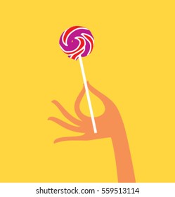 Lollipop in a hand. Vector illustration.