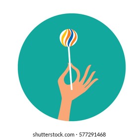 Lolly pop in a hand. Vector illustration.