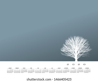 A lone tree stands strong in a barren winter landscape.  With a 2020 calendar  