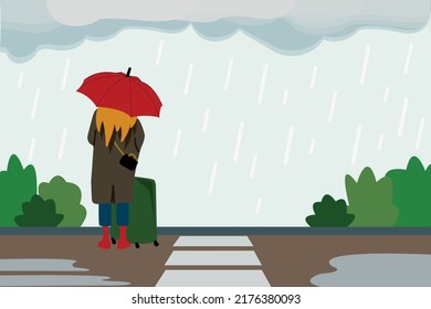 A lonely girl with an umbrella in the rain stands alone on the street. The concept of mental health problems, grief, suffering