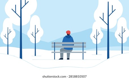 Lonely man in a blue jacket and red beanie sits on a park bench looking at snowy winter trees and mountains.