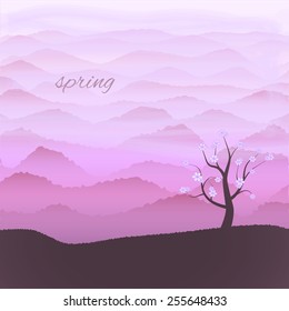Lonely tree in bloom on the edge of a high hill, messenger of spring