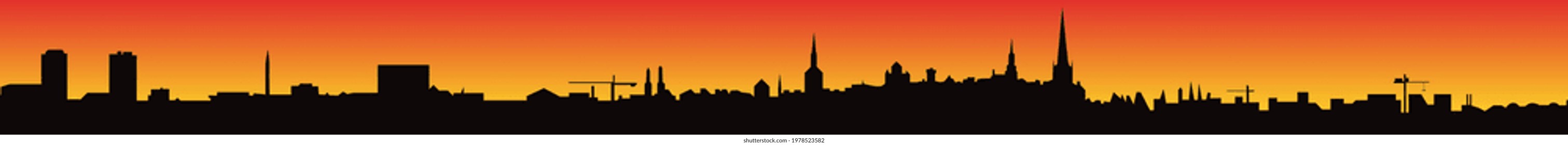 Long city skyline against sunset. Footer for website.